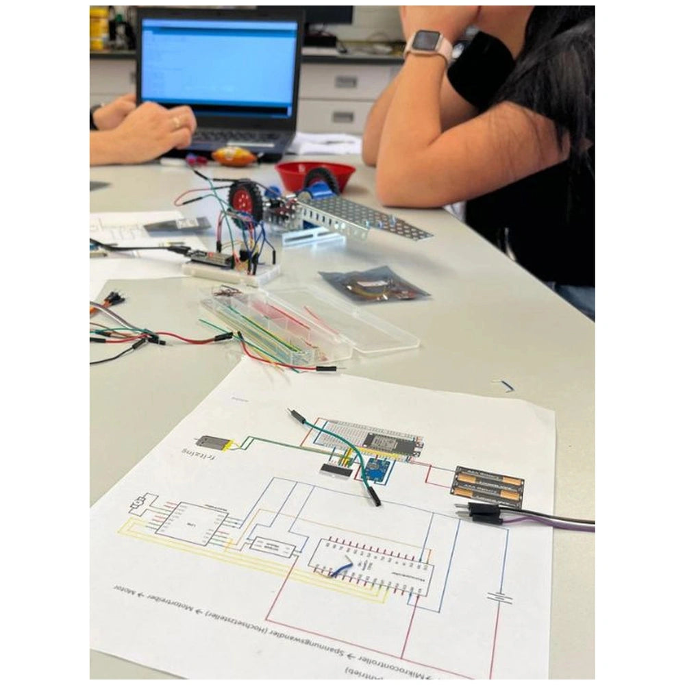 Eitech Motorcycle 1 construction set features colorful electronic components on a white breadboard with connected wires.