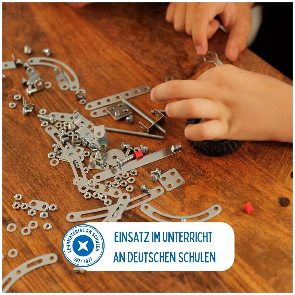 Eitech Rubin Rocket Racer Blue construction set featuring silver metal parts, red screws, and a brown wooden surface.