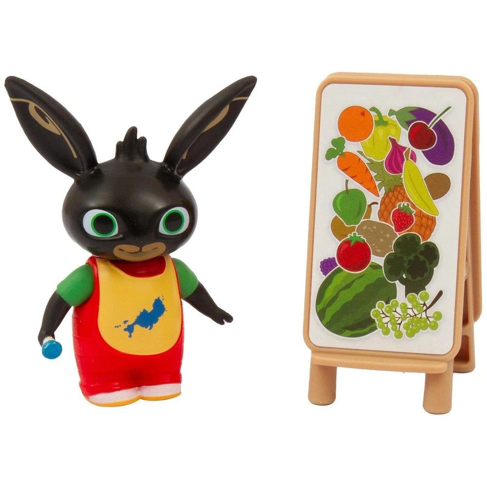Golden Bear Lets Paint with Bing plush figure in black with green and yellow accents, packaged in a colorful fruit-themed box