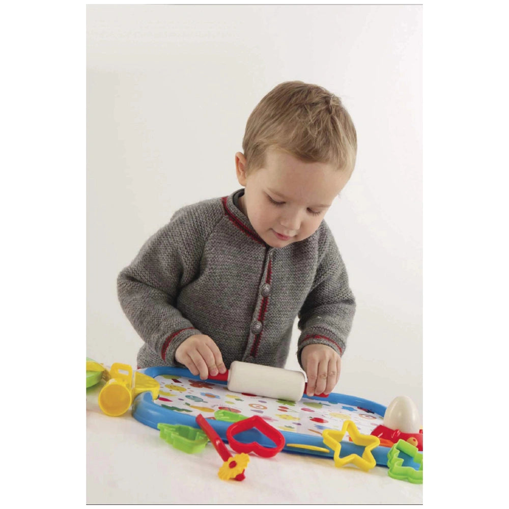 Gowi Baking Set Salzburg features a child in a gray sweater with toys, including a yellow cup and colorful objects on a patte