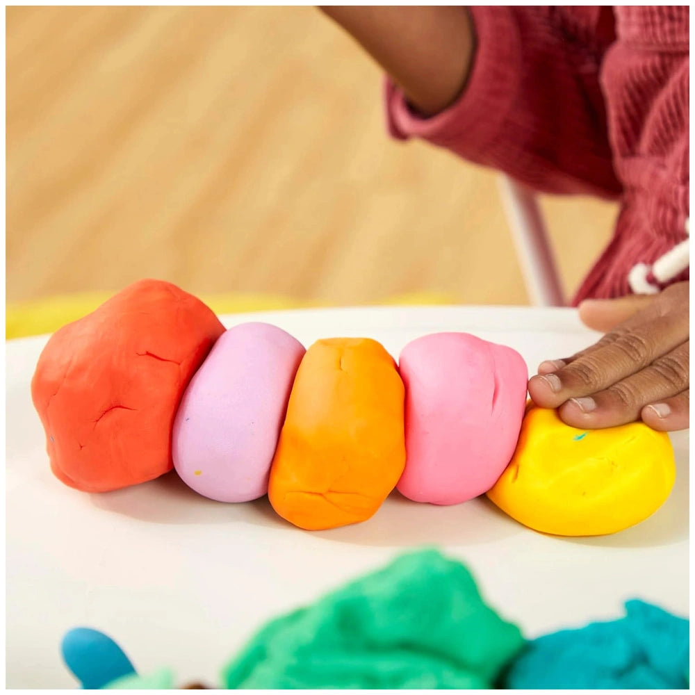 Play-Doh 15 Cans Party Bag featuring five smooth, cylindrical clay objects in red, pink, orange, yellow, and green.
