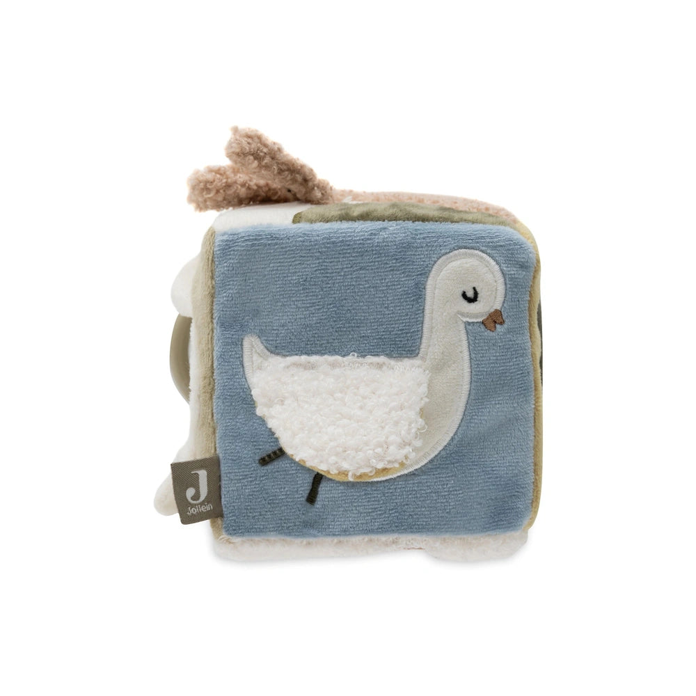 Jollein Activity Cube features a stylized duck in muted blue fabric packaging with a white background and closed eyes.