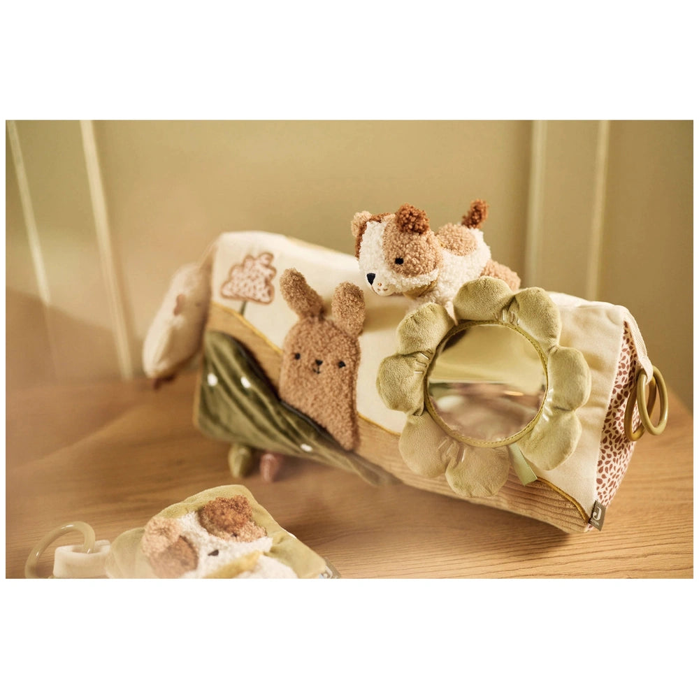 Jollein soft activity book in cream and brown with floral design, mirror, stuffed animals, and handle on a wooden table.