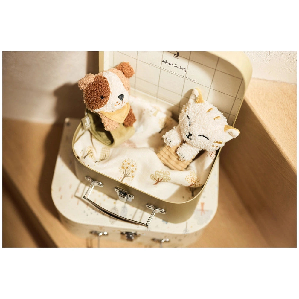 Jollein Wrist Rattle Tiny Park Charlie Cat Rattles displayed on a wooden table with a suitcase featuring various details.