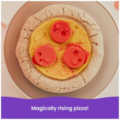 Kinetic Sand Squish Pizza features a golden-brown crust topped with vibrant red and yellow ingredients on a plate.