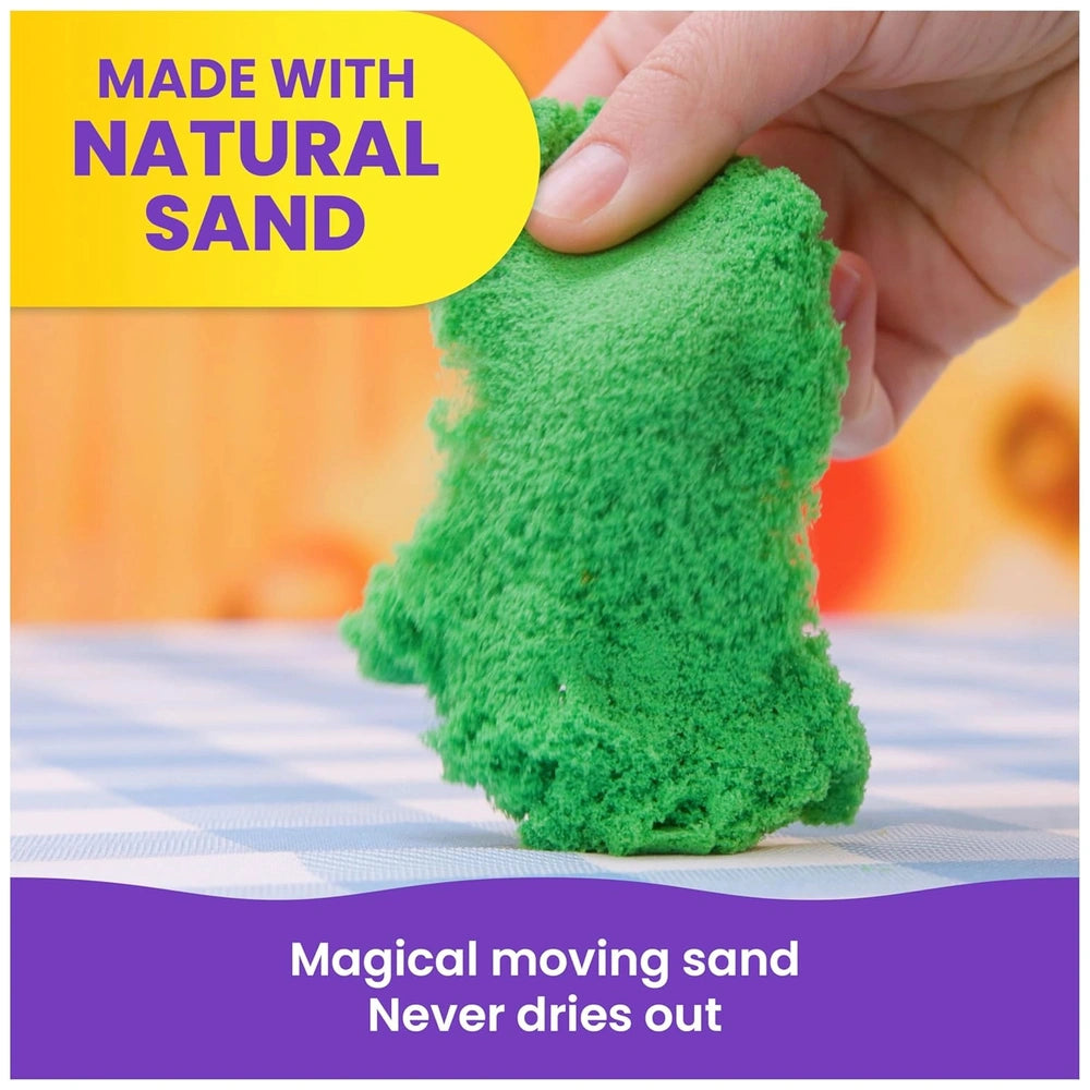 Kinetic Sand in vibrant green is held by a hand on a checkered tablecloth, with text overlay about its natural composition.