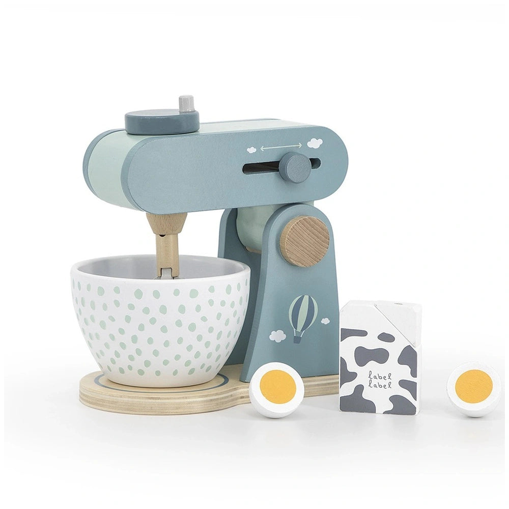 White ceramic bowl with green polka dots on a wooden table, featuring toy sewing machine and various colored eggs.