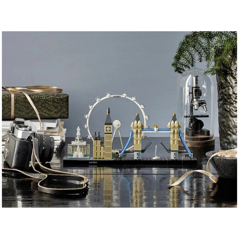 Lego Architecture London construction set displayed on a reflective tabletop with various models and objects in black, white,