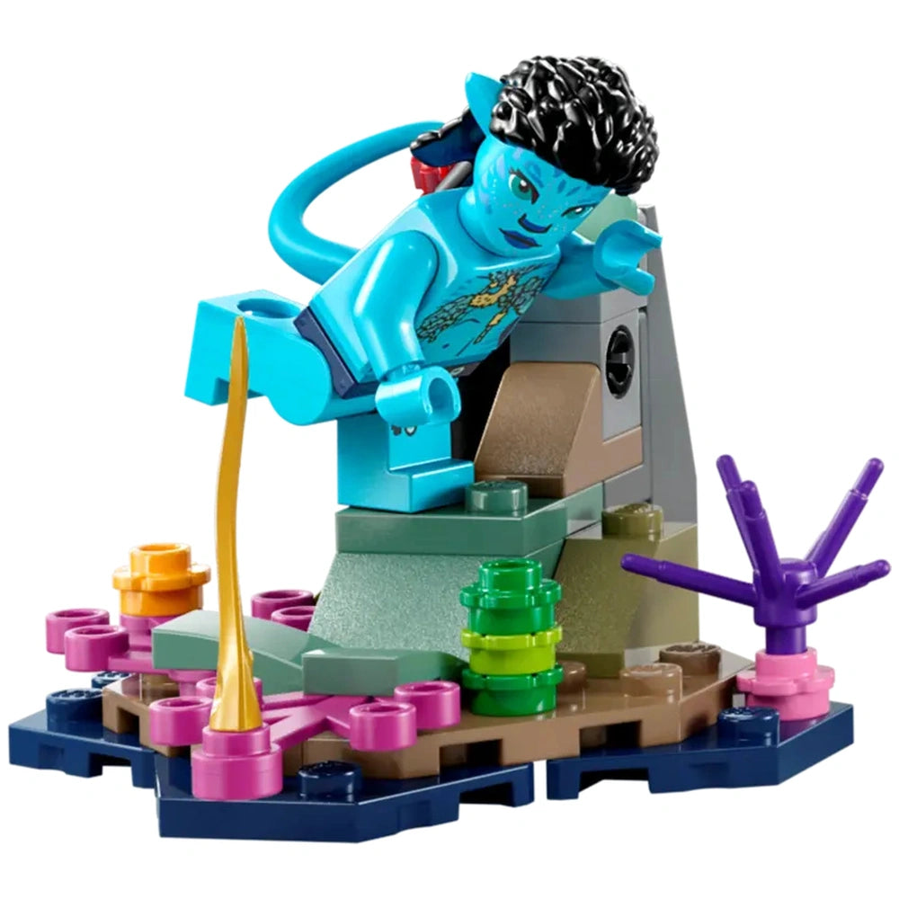 A turquoise Lego minifigure resembling a Na'vi character leaps from a rocky base surrounded by colorful underwater plants and coral.