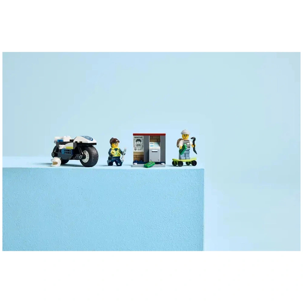 LEGO City Police Motorcycle Chase set featuring a police motorbike, two minifigures, a skateboard, and a backdrop of blue.