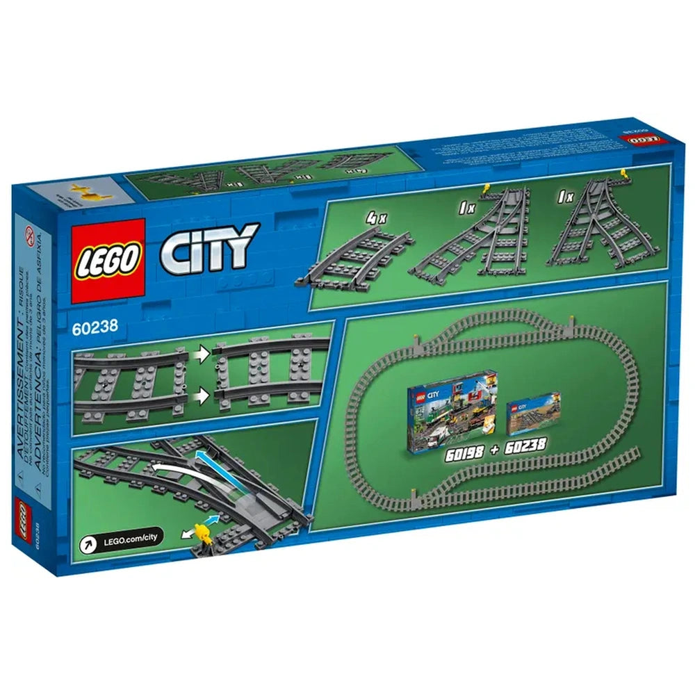 LEGO City Switch Tracks construction set box featuring four curved tracks, one left switch track, one right switch track, and visual instructions on a vibrant green background. The box highlights compatibility with existing LEGO sets for enhancing rail layouts.