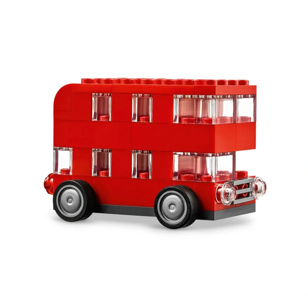 Bright red LEGO® double-decker bus with transparent windows, featuring four wheels, displayed at an angle to highlight its detailed design.