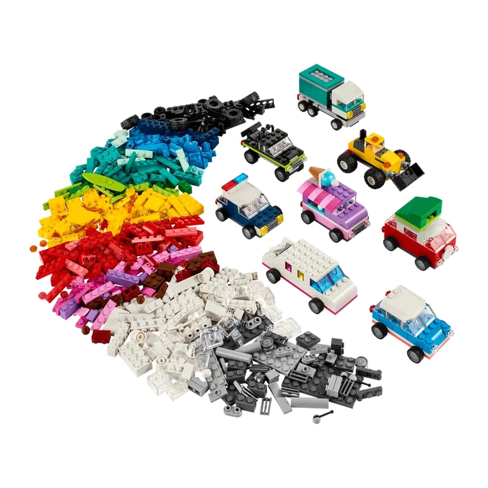 A vibrant assortment of colorful LEGO bricks in red, blue, green, yellow, and pink, alongside various assembled toy vehicles including a police car, ice cream truck, and off-road vehicle, capturing the essence of creative play.