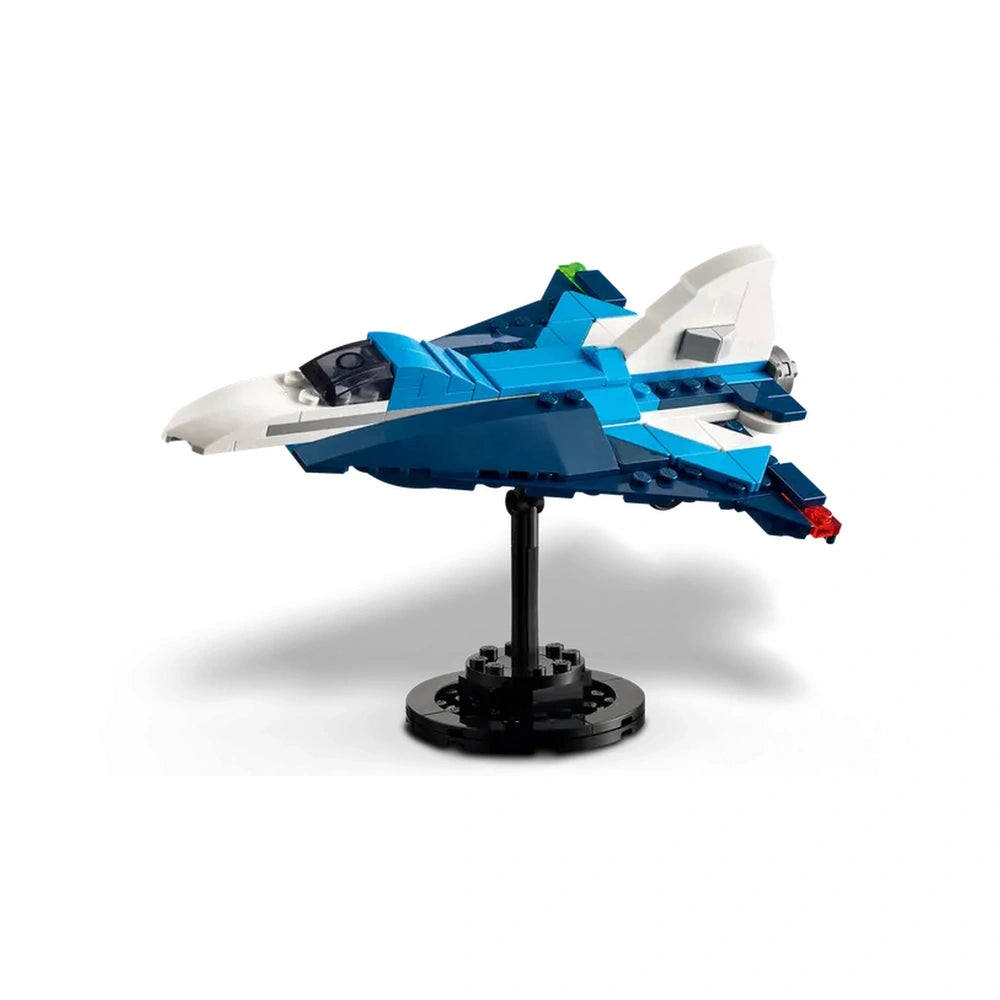 Blue LEGO® Creator race plane model with a sleek design, white nose, and rotating propeller, displayed on a black stand.