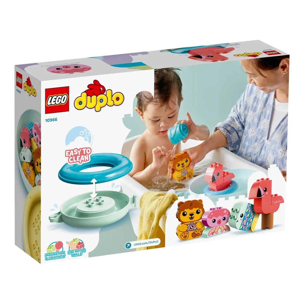 A toddler enjoying bath time, pouring water from a blue cup onto a floating lion toy, with a playful flamingo and octopus nearby. An adult engages with the child, both smiling. The colorful bath toys are displayed in a bright, cheerful setting, emphasizing fun and creativity.