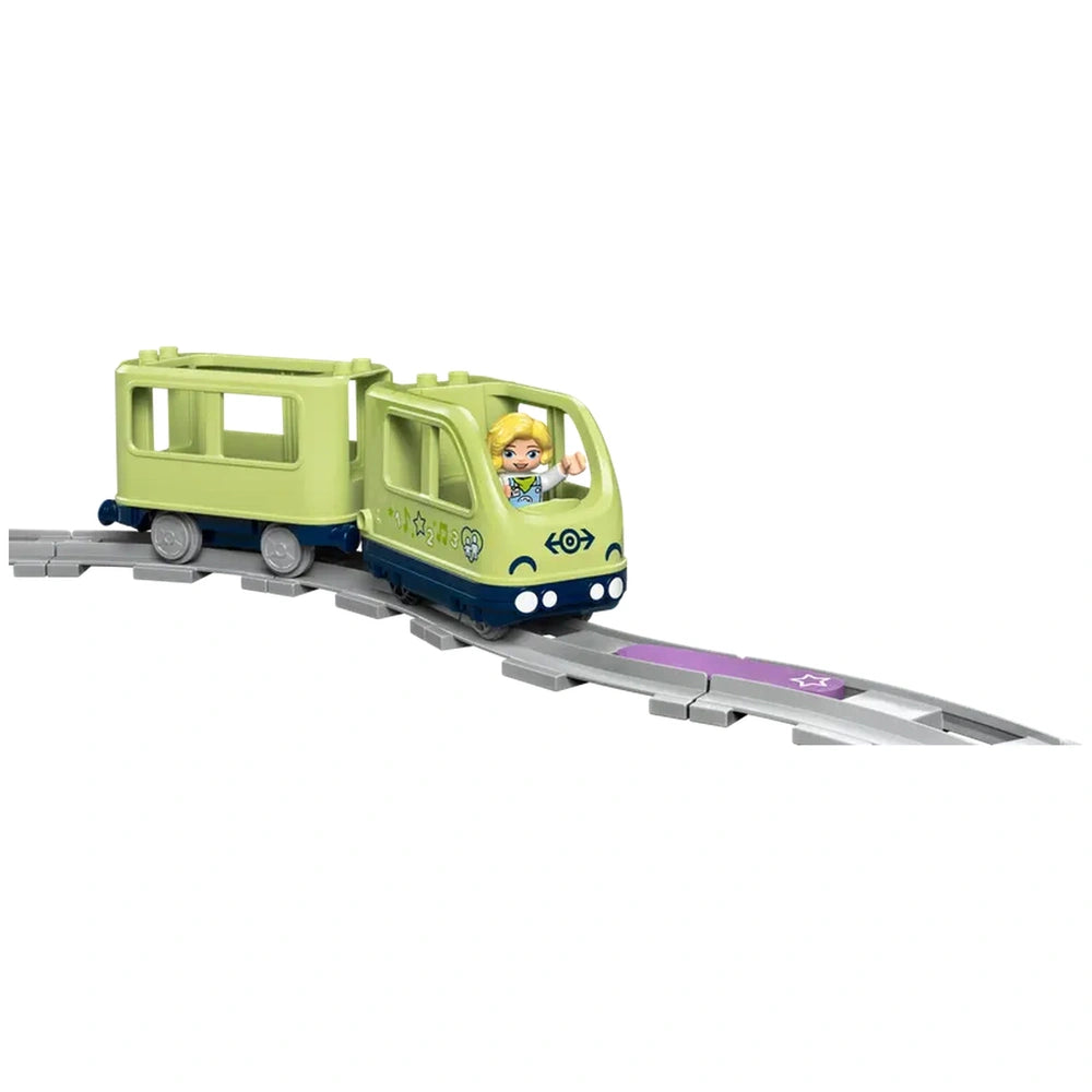 LEGO® DUPLO® Interactive Adventure Train, featuring a smiling blond driver, colorful train engine, and a section of track with purple highlights.