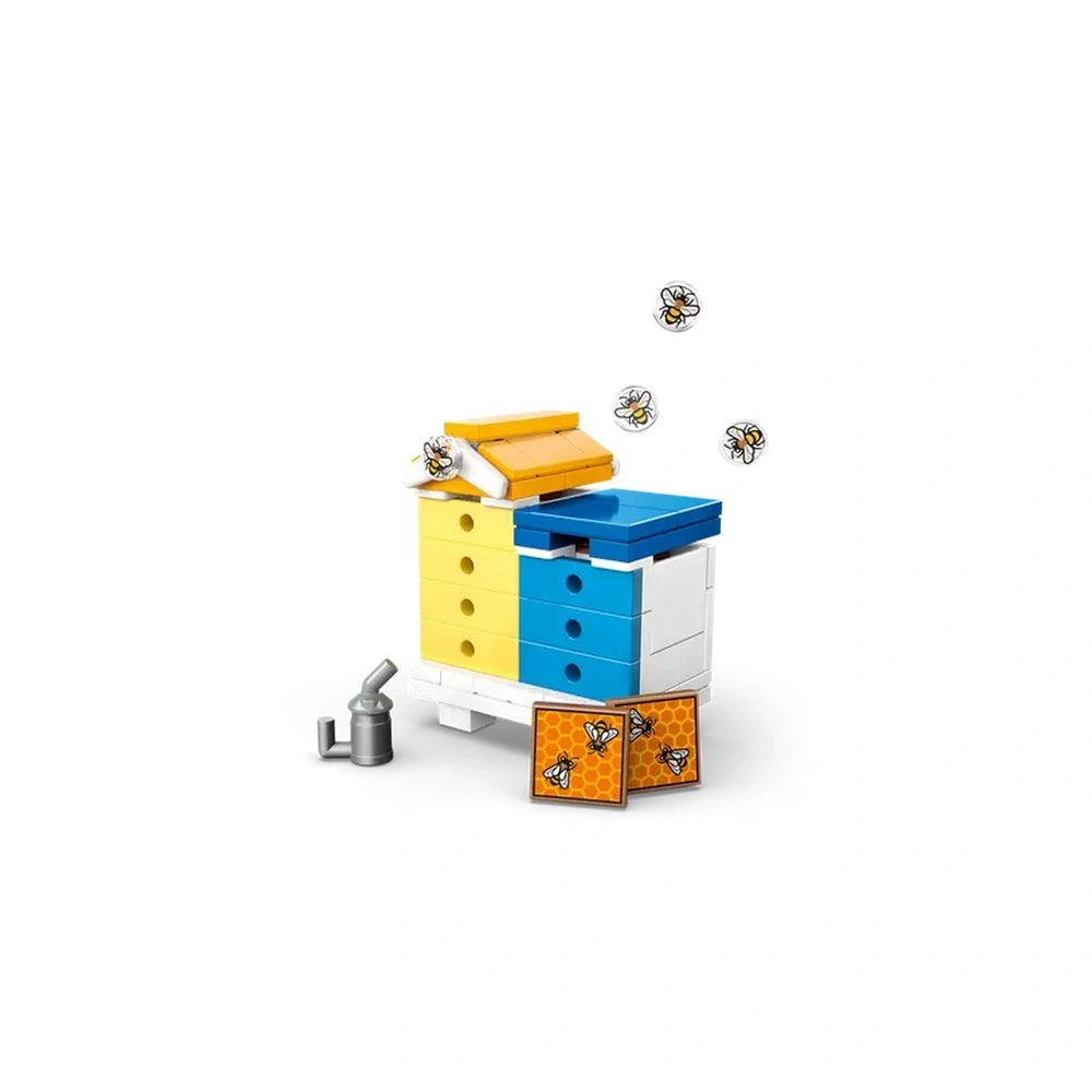 LEGO Friends Beekeepers’ House with blue and yellow hives, a smoking tool, and honeycomb panels, surrounded by playful bee figures.