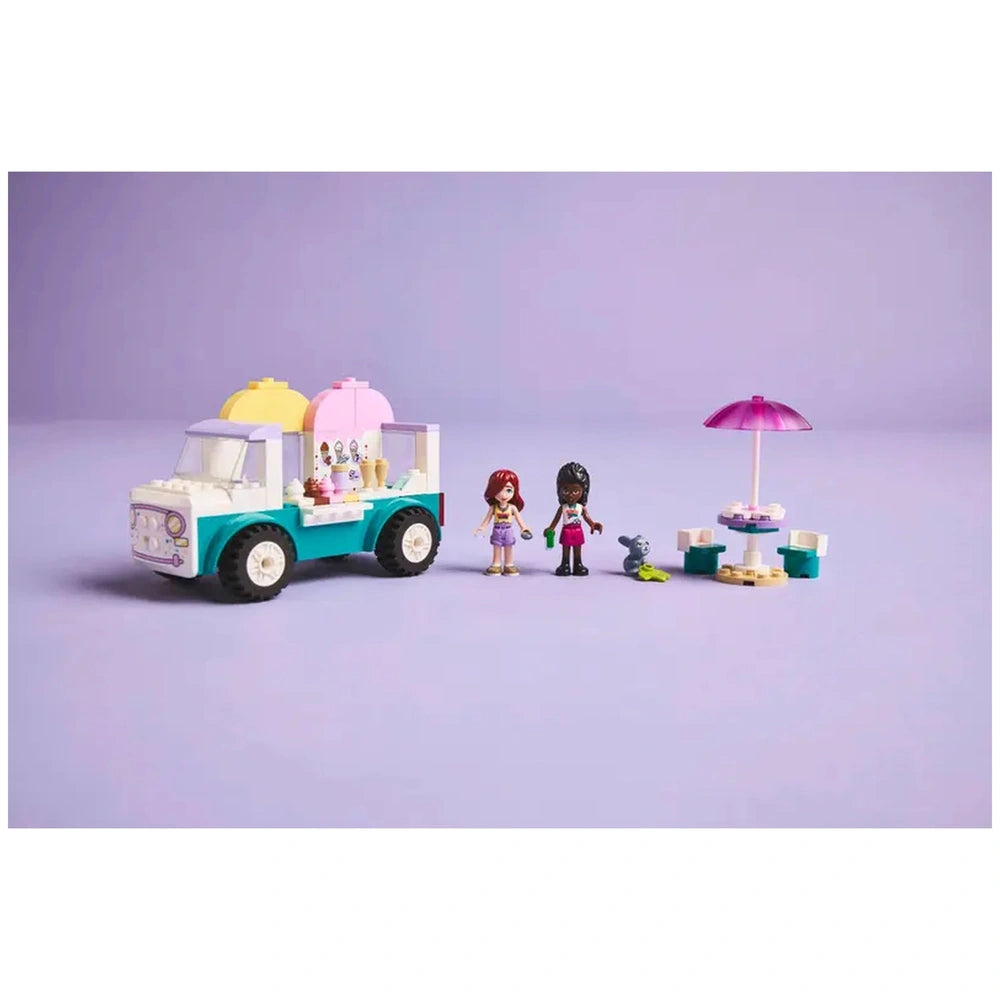 Lego Friends Heartlake City Ice Cream Truck set featuring two minidolls, a bunny figure, and a colorful ice cream truck with an umbrella table.
