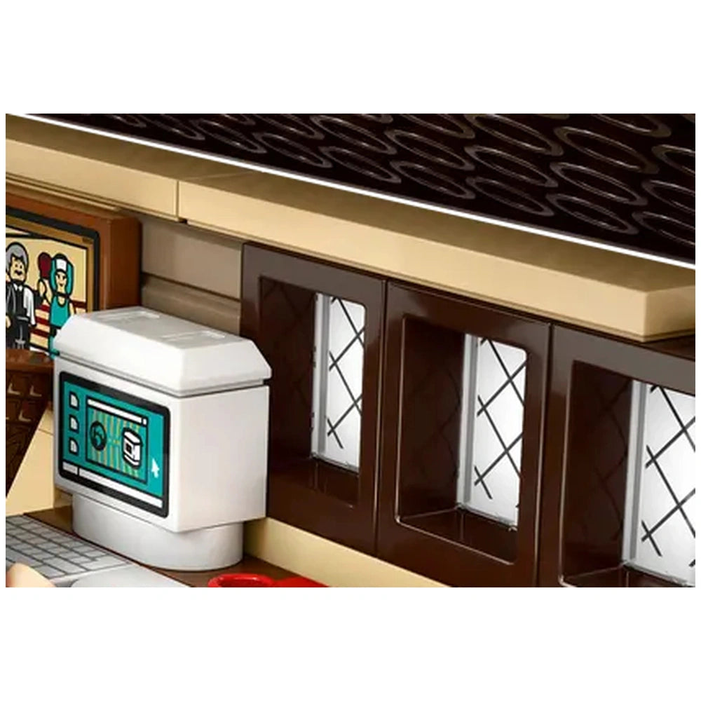 Detailed view of the LEGO Harry Potter Aunt Marge's Visit playset, showcasing a kitchen area with a white refrigerator, brown cabinets, and a stylized backdrop.