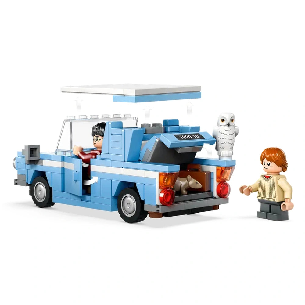 Blue LEGO Flying Ford Anglia with opening doors and removable roof, featuring Harry Potter at the wheel, Ron Weasley beside it, and Hedwig sitting on the back.