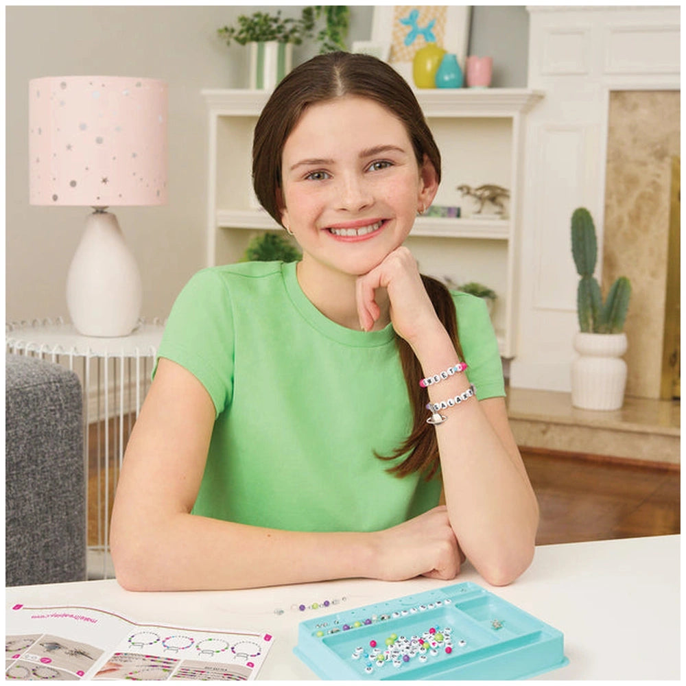 MAKE IT REAL Block ‘N’ Rock Bracelets showcased by a girl in a green shirt, surrounded by colorful beads and a decorative boo