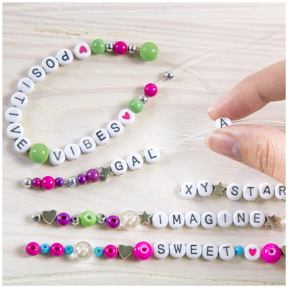 Block ‘N’ Rock Bracelets featuring glossy pink, green, and white beads with letters, numbers, and symbols on a flexible strin