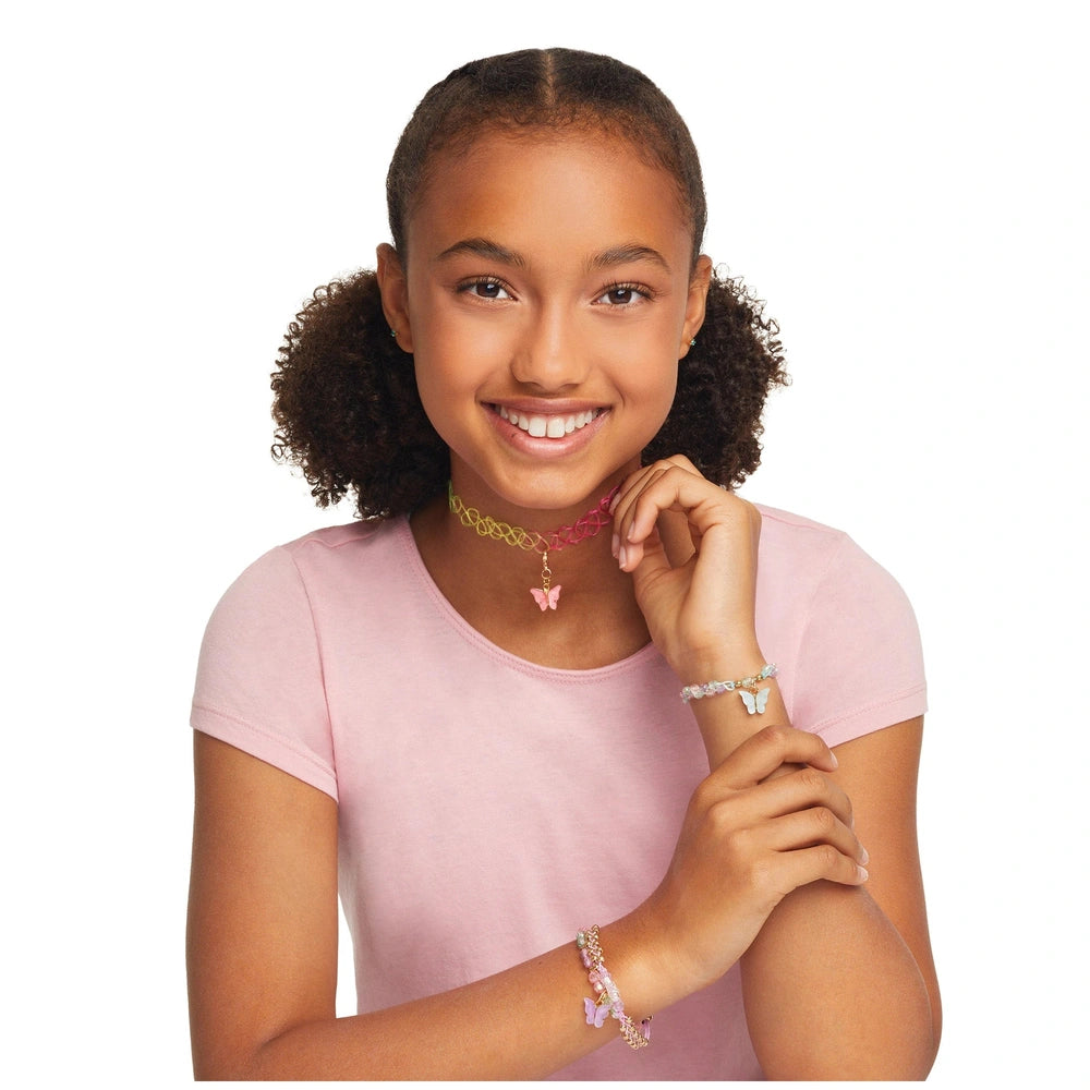 Butterfly Jewelry Set worn by a smiling girl in a pink top, featuring a heart pendant necklace and butterfly bracelet.