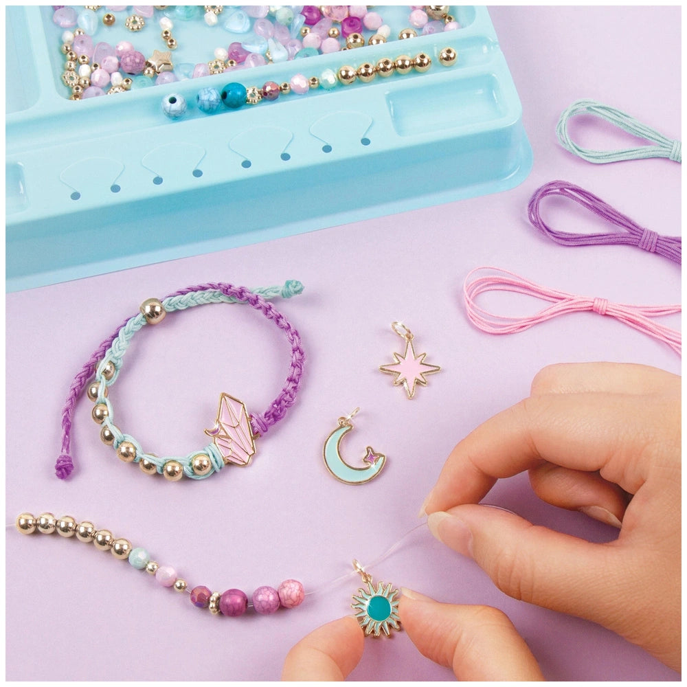 Celestial Stones Bracelets featuring gold, silver, blue, pink, purple, and clear beads in a blue plastic container.