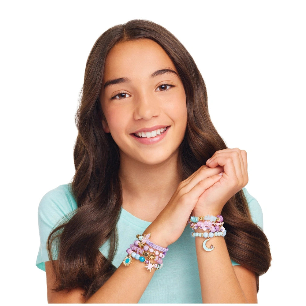 Celestial Stones Bracelets worn by a smiling girl in a light blue top, showcasing multicolored designs on her left wrist.