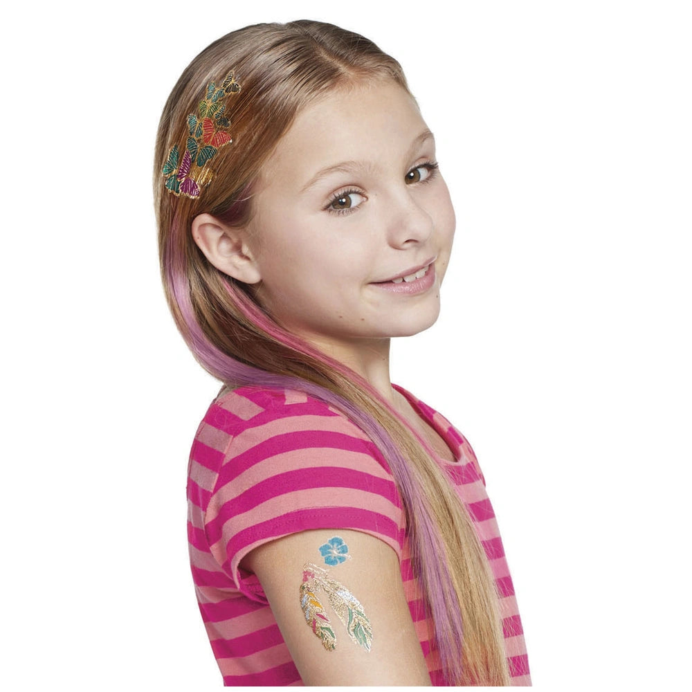 Young girl with long pink and purple hair wearing a pink and white striped shirt, adorned with colorful tattoos and stickers.
