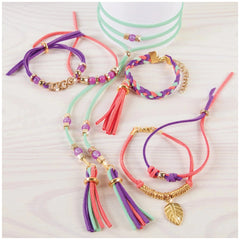 Gold link suede bracelets featuring colorful tassels and glass beads in a close-up arrangement.