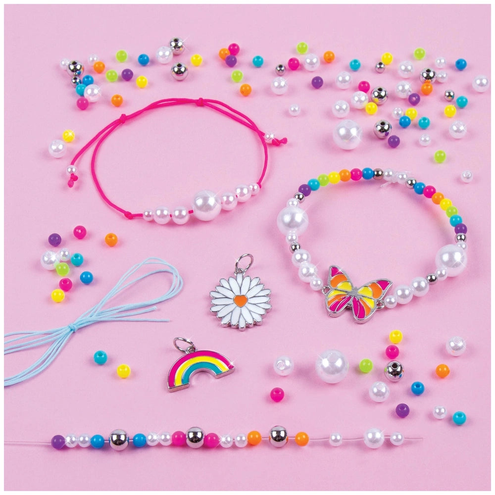 Rainbow Treasure Bracelets featuring shiny multi-colored beads, a silver bracelet, and a pink stretchy hair tie.