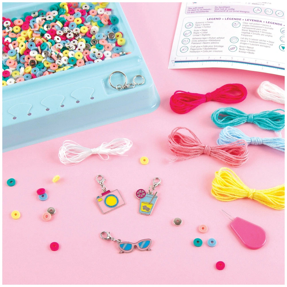 MAKE IT REAL Summer Vibes Heishi Bead Set featuring a blue container with colorful beads, scissors, and a clear bag on a pink