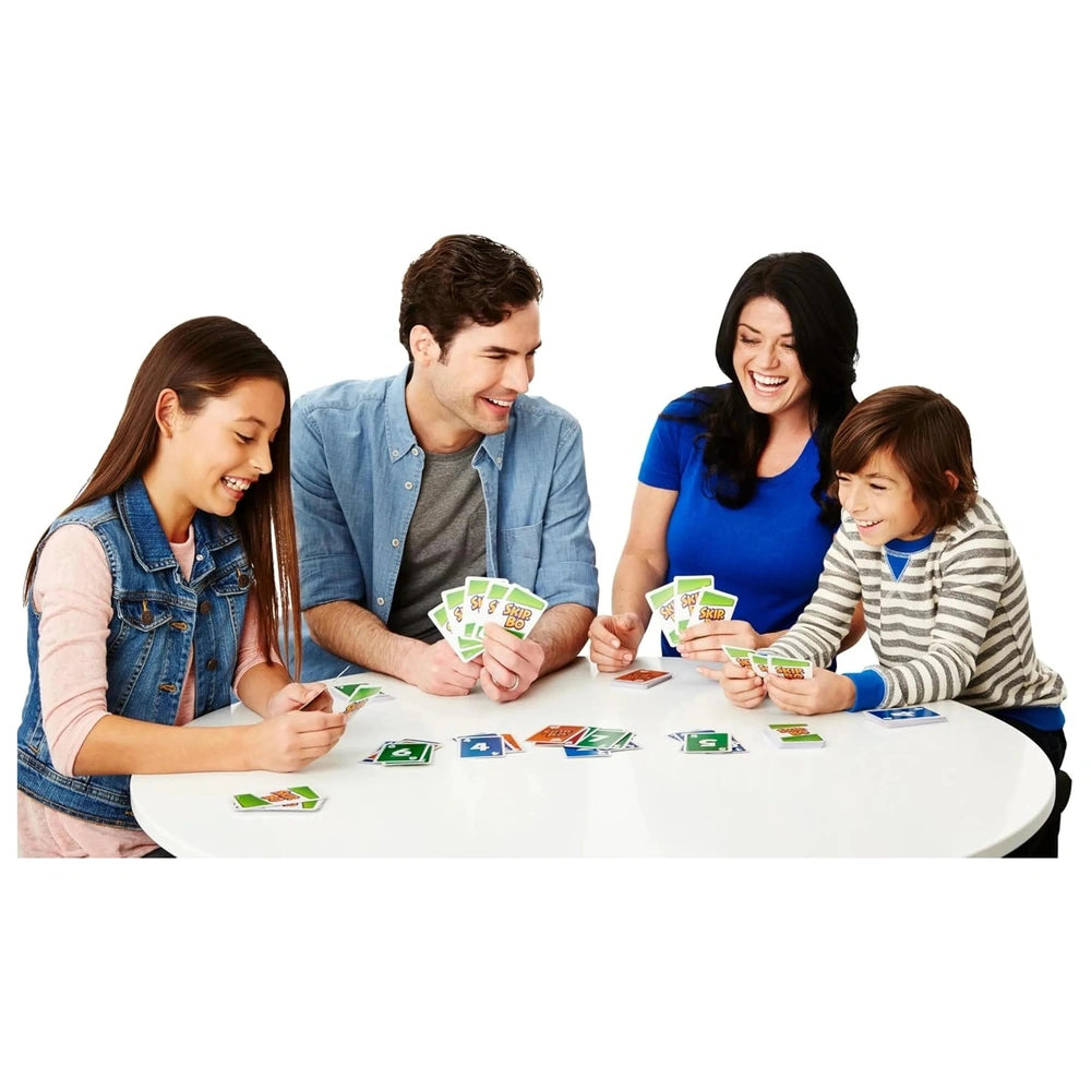 Skip-Bo Ultimate Sequencing Card Game shown with four people playing at a white table, surrounded by colorful clothing and pl