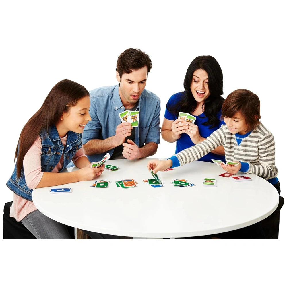 Mattel Skip-Bo Ultimate Sequencing Card Game displayed on a white table with four people playing and colorful cards visible.