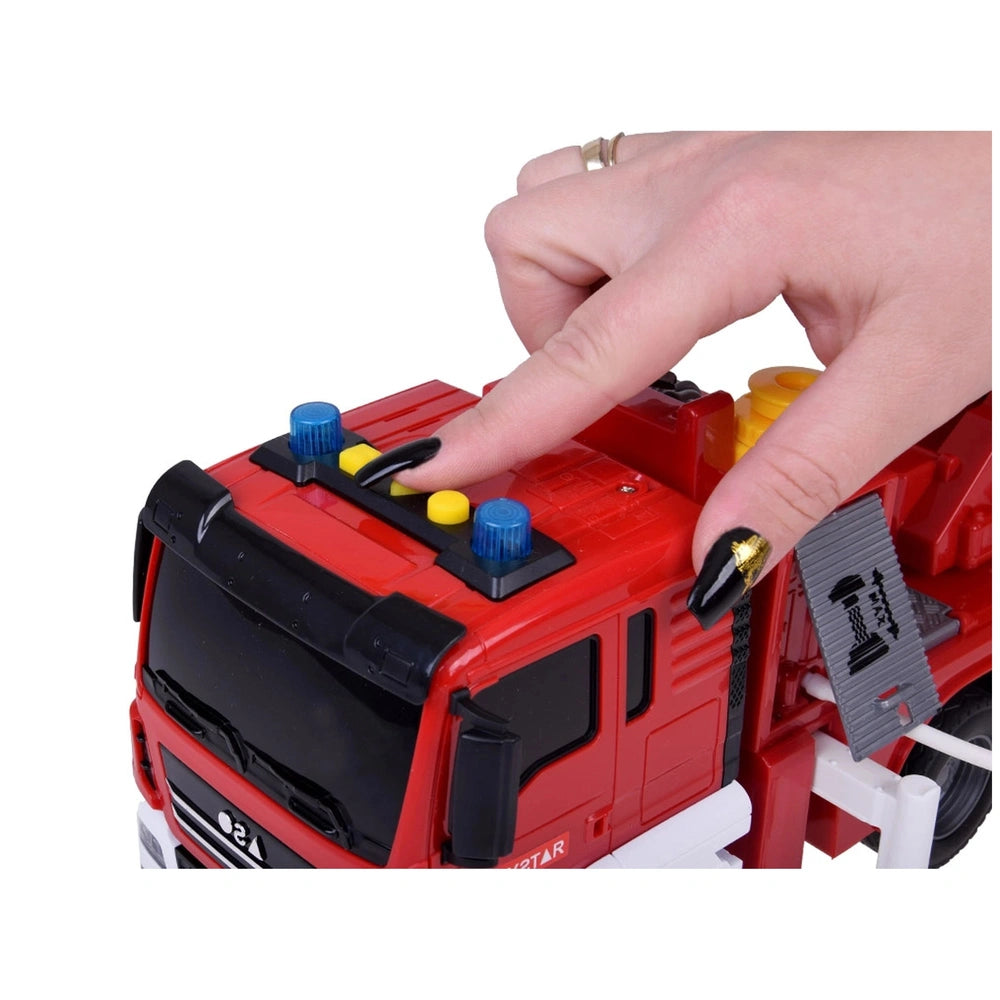Red toy fire engine truck is being activated by a hand with nail polish pressing a button on its body.