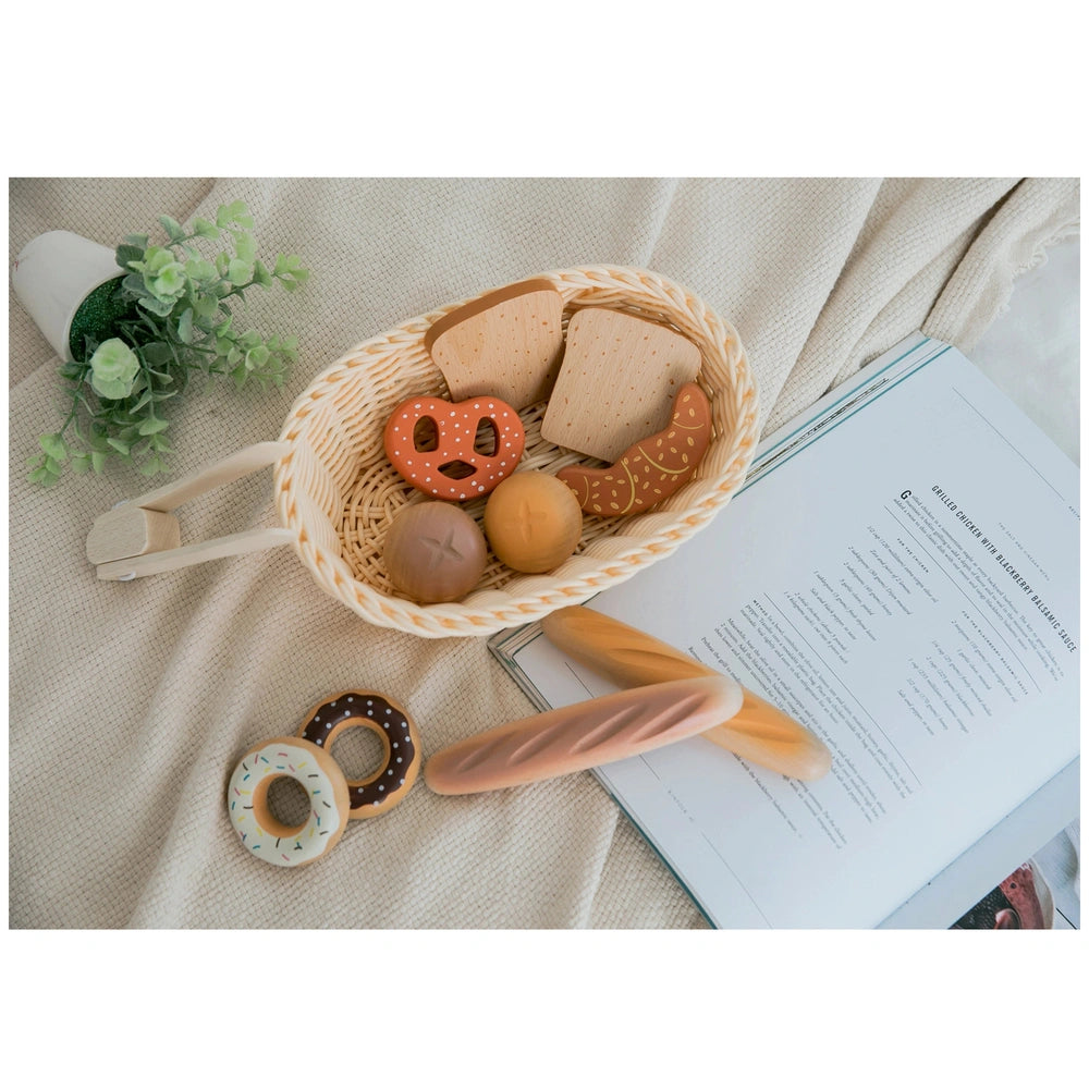 New Classic Toys bread basket with woven materials, featuring brown bread, eggs, donuts, and a wooden rolling pin.