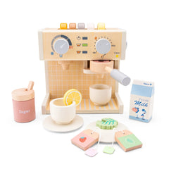 Wooden toy coffee machine with cups, lemon saucer, cake, and sugar container on an orange and yellow checkered surface.