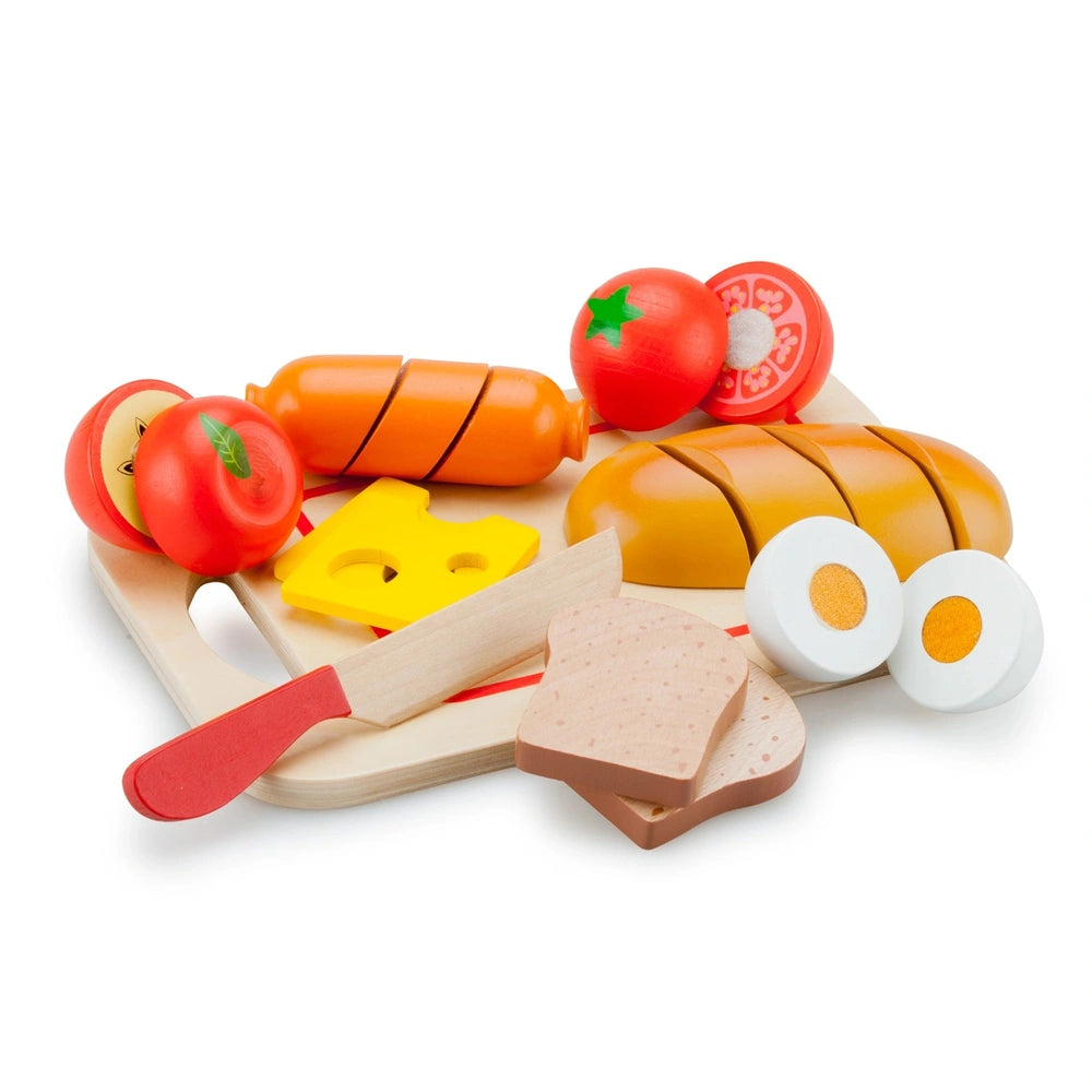 New Classic Toys cutting set features a wooden board, red-handled knife, and various colorful plastic food items for role pla