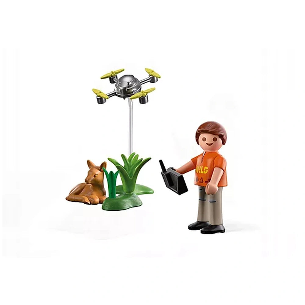 Playmobil Fawn Rescue toy set featuring a figure in an orange shirt, brown pants, and a green base with a plant and animal.