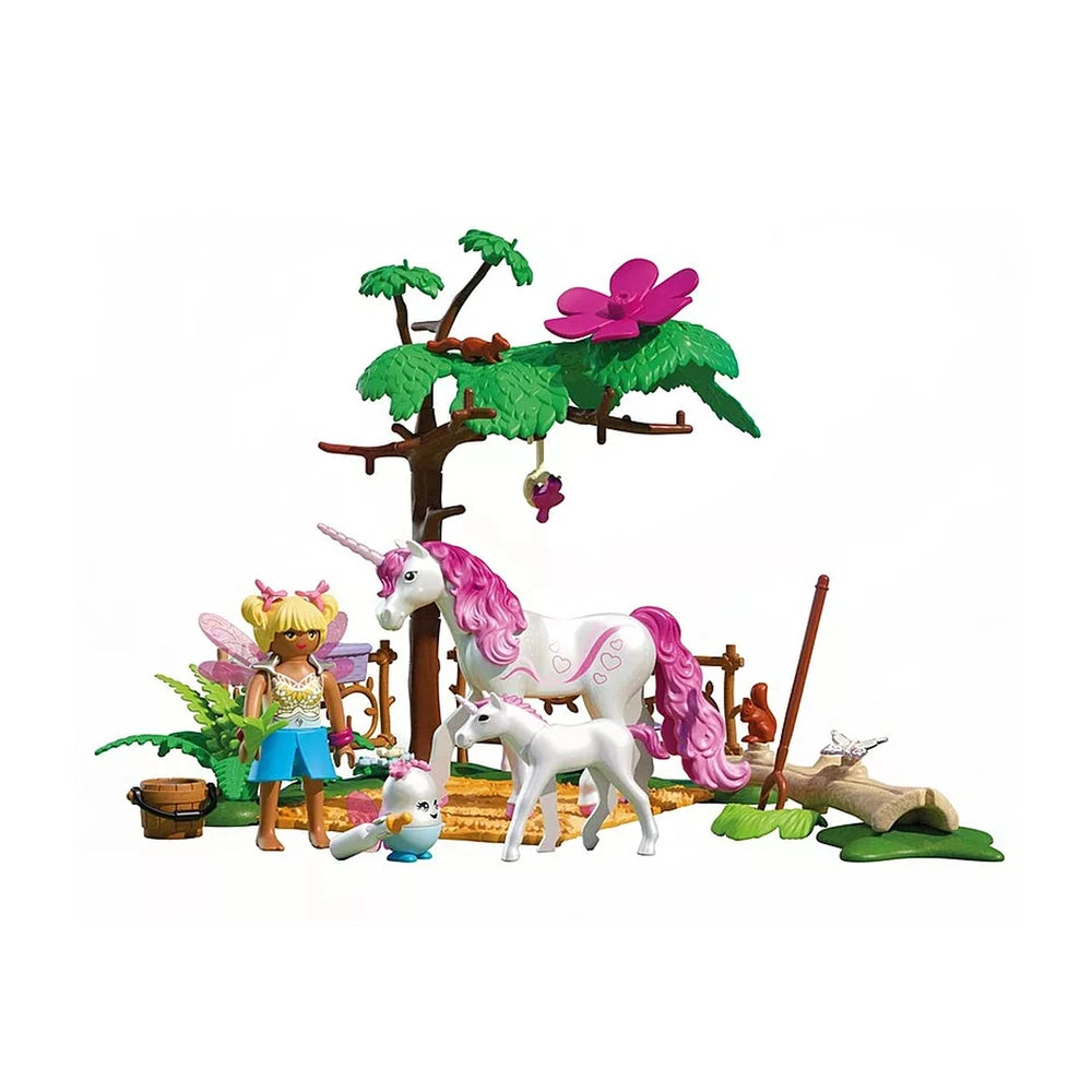 Playmobil Magical Unicorn Stable toy playset features a colorful unicorn, tree, and bird in a vibrant flat lay arrangement.