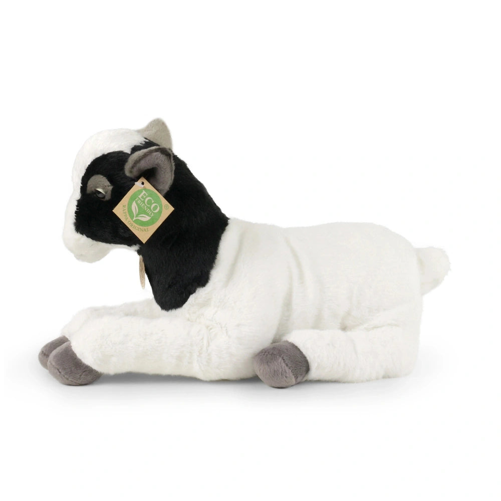 Plush goat stuffed animal in black and white, resting on a light surface with an eco-friendly tag attached to its ear.