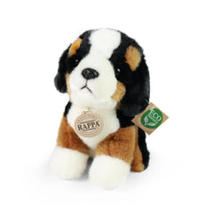 Plush mountain dog toy in brown, white, and black, featuring an eco-friendly label and soft texture against a light backgroun