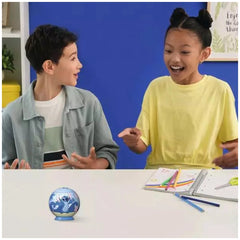 Ravensburger 3D Puzzle Ball featuring Disney's Stitch is being explored by two smiling children at a craft table.