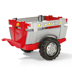 Rollyfarm trailer in red and gray plastic with glossy and matte finishes, featuring a black wheel and "Farm Trailer" text.