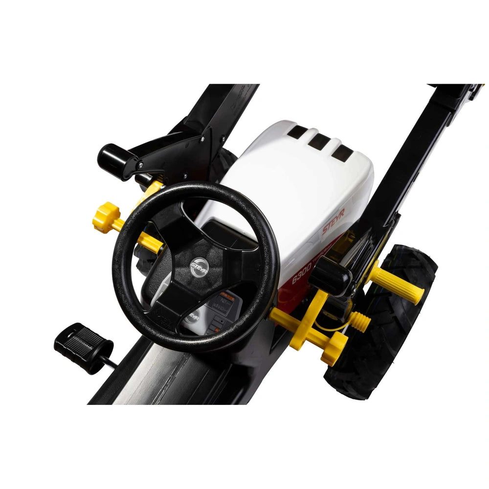 Rollyfarmtrac Premium II Steyr 6300 Terrus CVT features a black steering wheel with a yellow center and horn button.