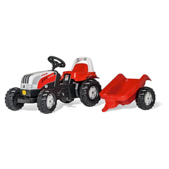 Rolly Toys Rollykid Steyr 6165 Cvt Tractor with a red trailer, featuring a metallic steering wheel and black wheels, on a whi