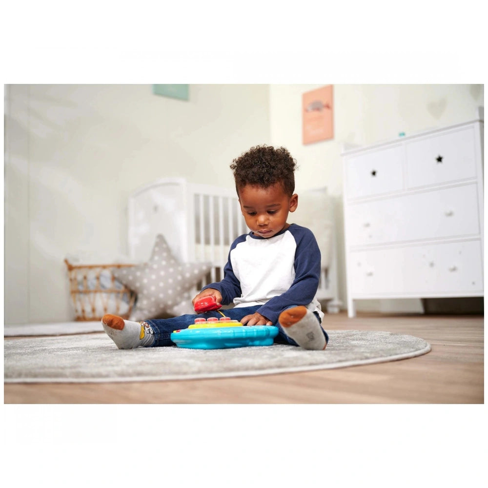 Simba ABC Colorful Telephone - A child plays with a vibrant toy telephone on a cozy rug in a beautifully decorated nursery.