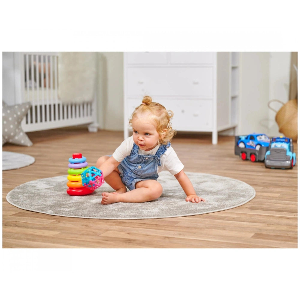 Simba ABC Stacking Ring Pyramid with a toddler playing on a rug in a colorful childs bedroom, surrounded by toys.
