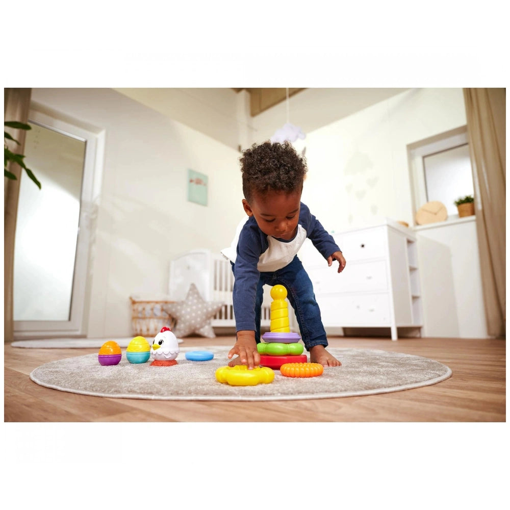 Simba ABC Stacking Ring Pyramid with a child playing on a rug, surrounded by colorful stacking toys in a cozy playroom.